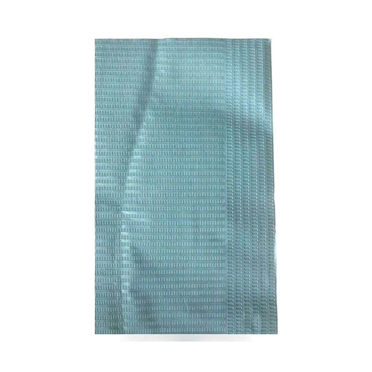 Folded UMD 46 x 56 cm dental bibs with perforated cut neck and adhesive strip.